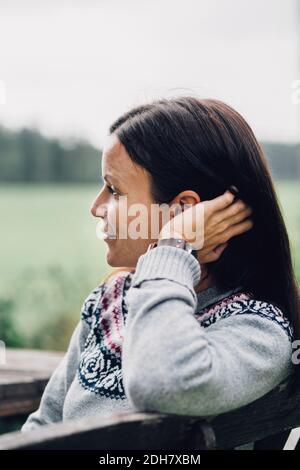 Thoughtful woman relaxing at organic farm Stock Photo