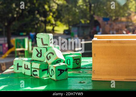 Green wooden blocks on table outside kindergarten Stock Photo