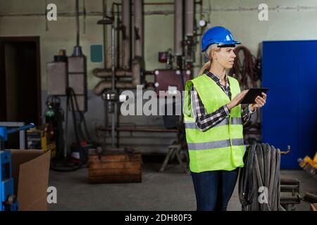 Female manual worker using digital tablet in factory Stock Photo