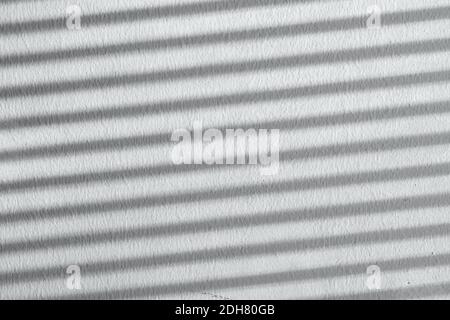 Shadow on a white striped wall. Natural background from blinds. High quality photo Stock Photo