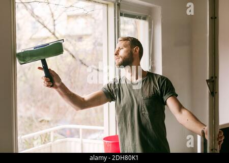 Man cleaning glass window Stock Photo