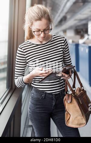 Businesswoman using mobile phone in office Stock Photo