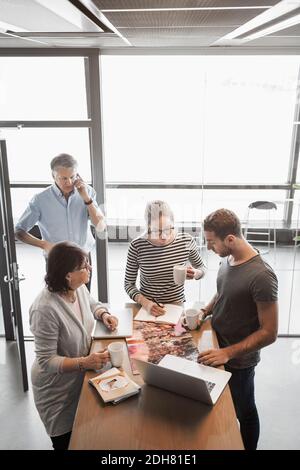 Business people working at counter in office cafe Stock Photo