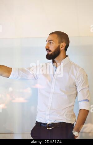 Confident businessman giving presentation in office Stock Photo