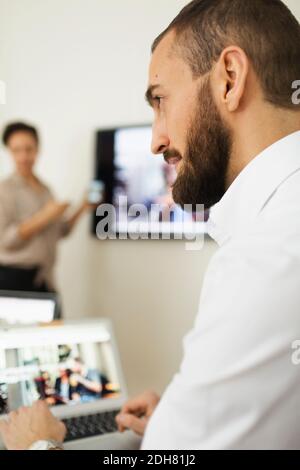 Young businessman looking away in office Stock Photo