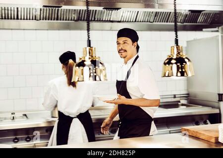 Chefs working in commercial kitchen Stock Photo