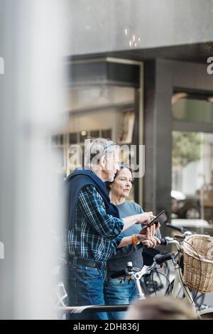 Senior couple using digital tablet outdoors Stock Photo