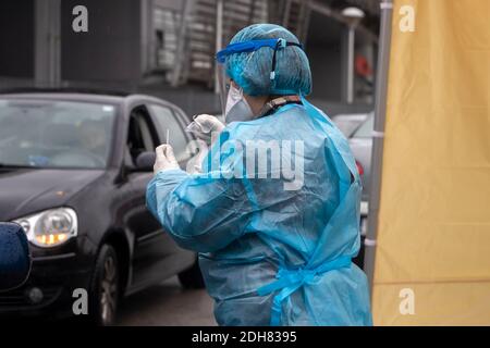 Thessaloniki, Greece - December 10, 2020. A medical worker wearing special suit to protect against coronavirus, conduct a 'drive through' rapid testin Stock Photo