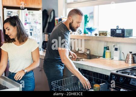 Couple working together in kitchen Stock Photo