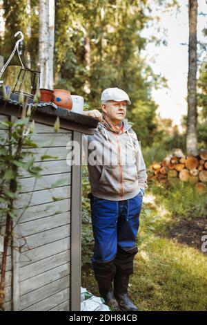 Thoughtful gay man standing on field Stock Photo