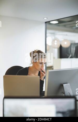 Mature businesswoman using desktop computer in office Stock Photo