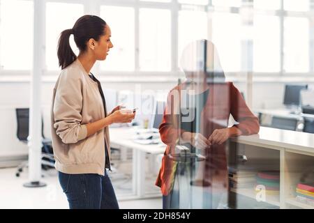Two businesswomen discussing in office Stock Photo