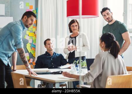 Team of business people discussing project at table in office Stock Photo