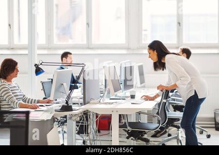 Business people using computers at desk in office Stock Photo
