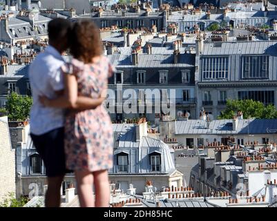 Paris (France): district of Montmartre in the 18th arrondissement (district). Buildings viewed from the Hill of Montmartre and couple embracing each o Stock Photo