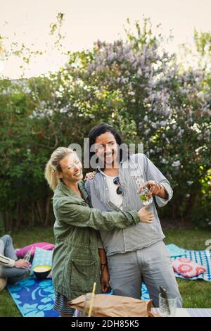 Happy couple looking away while enjoying at summer party Stock Photo