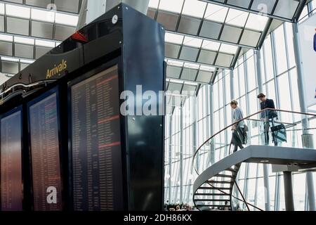 Low angle view of business colleagues moving down steps in airport Stock Photo
