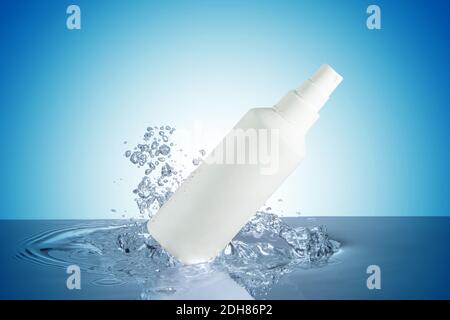sprayer and bubbles on water surface isolated on blue background Stock Photo