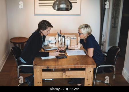 Female industrial designers using digital tablet at home office Stock Photo