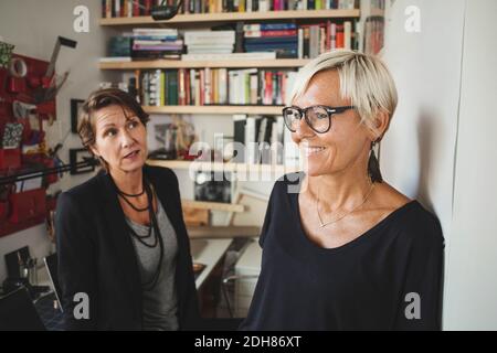 Smiling industrial designers talking to colleague at home office Stock Photo