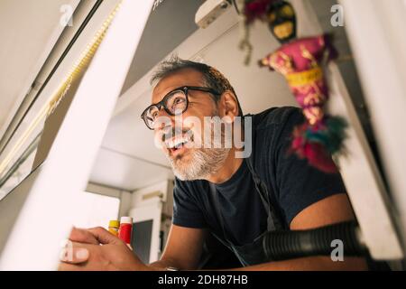 Close-up of happy male chef leaning on counter at food truck Stock Photo