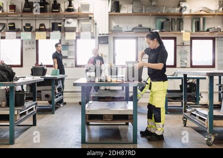 Side view of female high school student working on project in training class Stock Photo