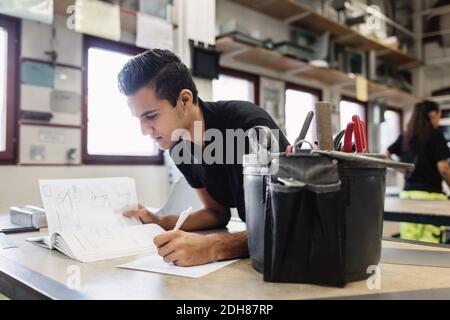 Male high school student taking notes in training class Stock Photo