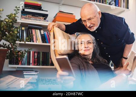 Senior couple taking selfie through mobile phone at home Stock Photo