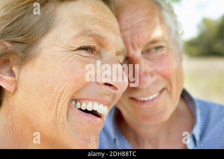 Close of cheerful couple looking away Stock Photo