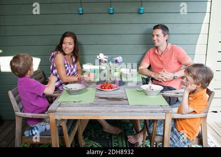 Family having breakfast together at porch Stock Photo