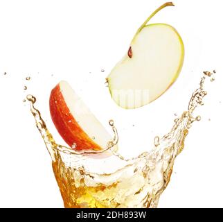 apple slices falling into splashing juice isolated on white Stock Photo