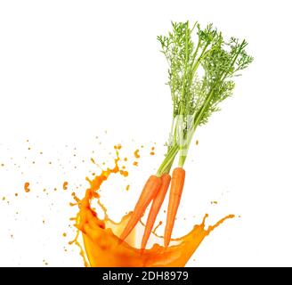 carrots falling into orange juice isolated on white Stock Photo