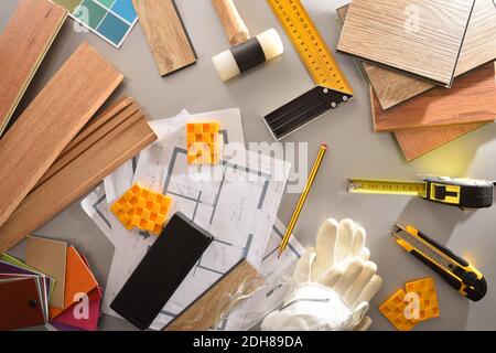 Work table of a parquet Installer with samples of wood materials and tools for interior project. Top view. Stock Photo