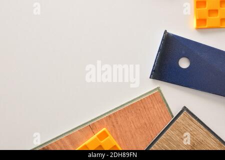 Detail of materials and tools on the white work table of a parquet installer. Top view. Stock Photo