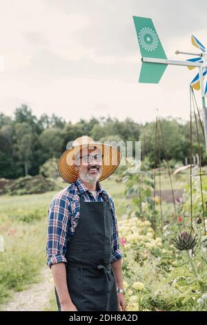 Portrait of happy farmer standing in farm against sky Stock Photo