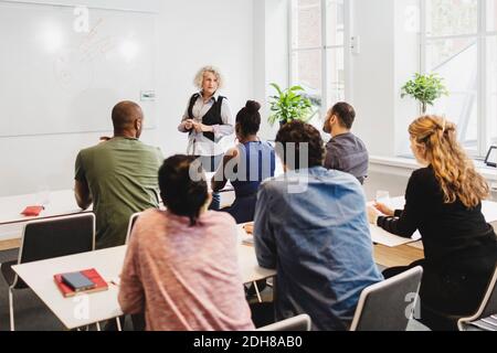 High angle view of students listening to teachers at language class Stock Photo