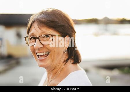 Portrait of confident senior woman smiling outdoors Stock Photo