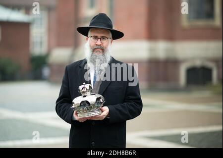 10 December 2020, Hamburg: Shlomo Bistritzky, State Rabbi of the Free and Hanseatic City of Hamburg, stands in front of the main church of St. Michaelis with a Torah crown of the Jewish community during a press event for the reconstruction of the Bornplatz synagogue. Photo: Daniel Reinhardt/dpa Stock Photo