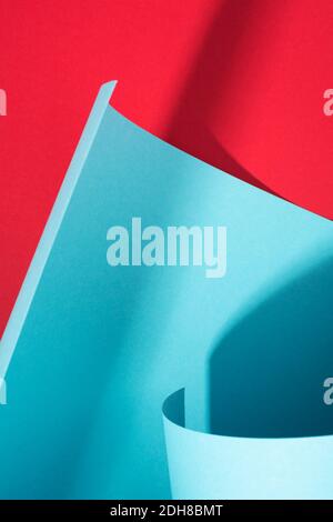 Curve paper texture, art background. Abstract geometric backdrop. Red and blue colors and shadows design. Stock Photo