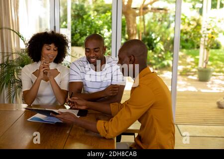 Young couple discussing with a financial adviser Stock Photo