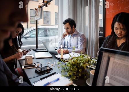 Creative business team working at table in modern office Stock Photo