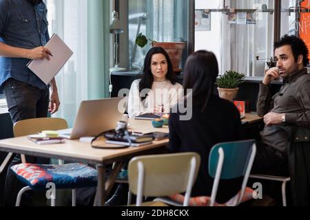 Business people sharing ideas in creative office Stock Photo