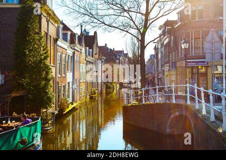 Street view with houses and canal in Delft, Holland at sunset Stock Photo