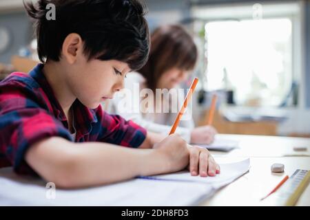 Serious students studying at desk in classroom Stock Photo