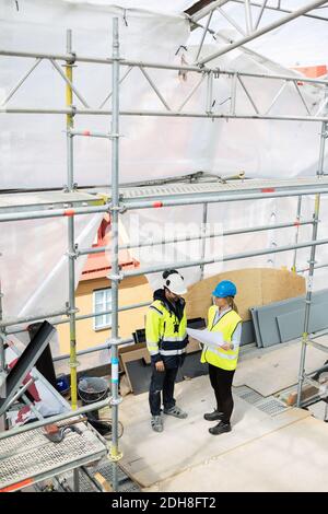 High angle view of female and male managers planning at construction site Stock Photo