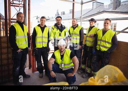 Portrait of confident professional workers posing at construction site Stock Photo