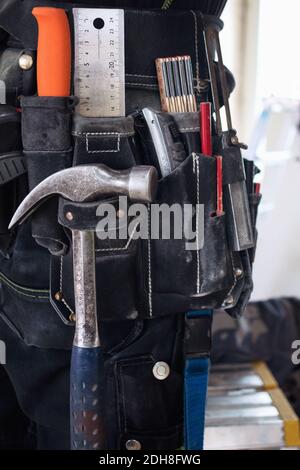 Midsection of construction worker wearing tool belt Stock Photo