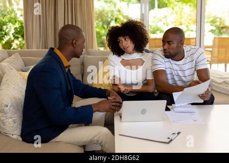 Young couple discussing with a financial adviser Stock Photo