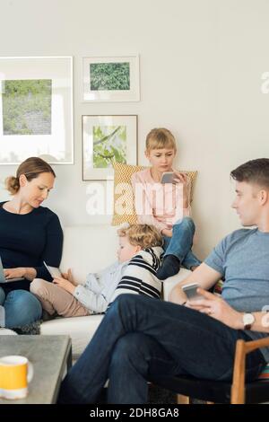 Family using technologies at home Stock Photo