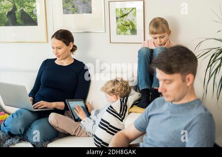 Family using technologies at home Stock Photo